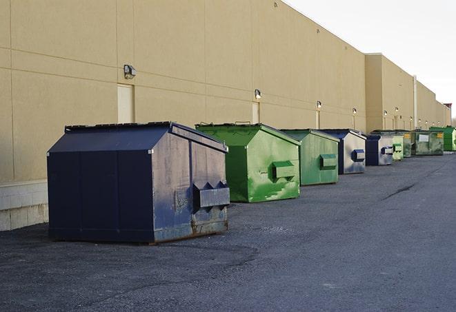 big yellow dumpsters on a construction lot in Astor